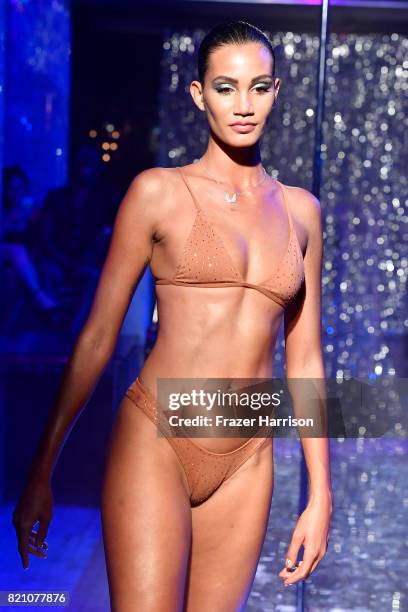 Model walks the runway at the SWIMMIAMI Minimale Animale 2018 Collection fashion show at Ora Nightclub on July 22, 2017 in Miami Beach, Florida.