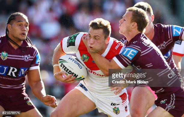Jacob Host of the Dragons is tackled during the round 20 NRL match between the St George Illawarra Dragons and the Manly Sea Eagles at WIN Stadium on...