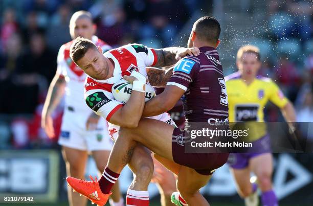 Tariq Sims of the Dragons is tackled by Dylan Walker of the Eagles during the round 20 NRL match between the St George Illawarra Dragons and the...