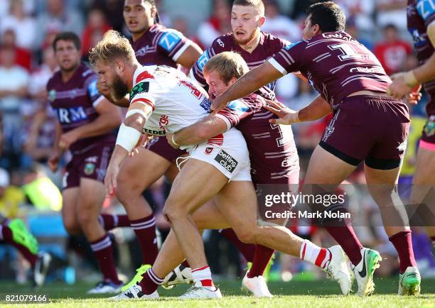 Jack De Belin of the Dragons is tackled during the round 20 NRL match between the St George Illawarra Dragons and the Manly Sea Eagles at WIN Stadium...