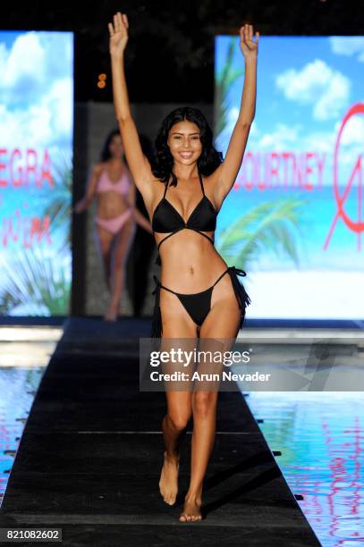 Model walks the runway at the Courtney Allegra fashion show during the Art Hearts Fashion at Miami Swim Week at SLS Hyde Beach on July 22, 2017 in...