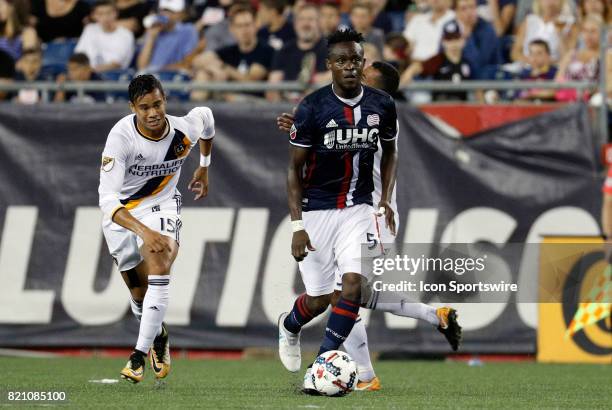 Los Angeles Galaxy forward Ariel Lassiter chases after New England Revolution midfielder Gershon Koffie during a regular season MLS match between the...