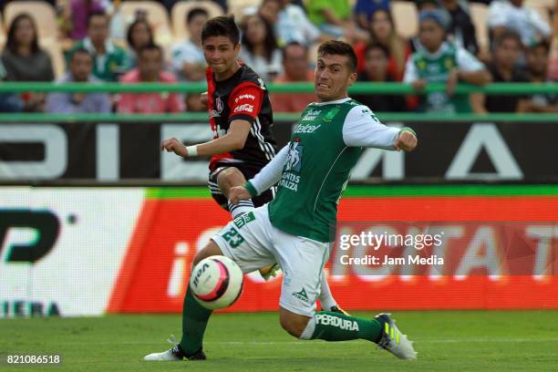 Brayan Garnica of Atlas shoots the ball as Juan Cornejo of Leon tries to block during the 1st round match between Leon and Atlas as part of the...