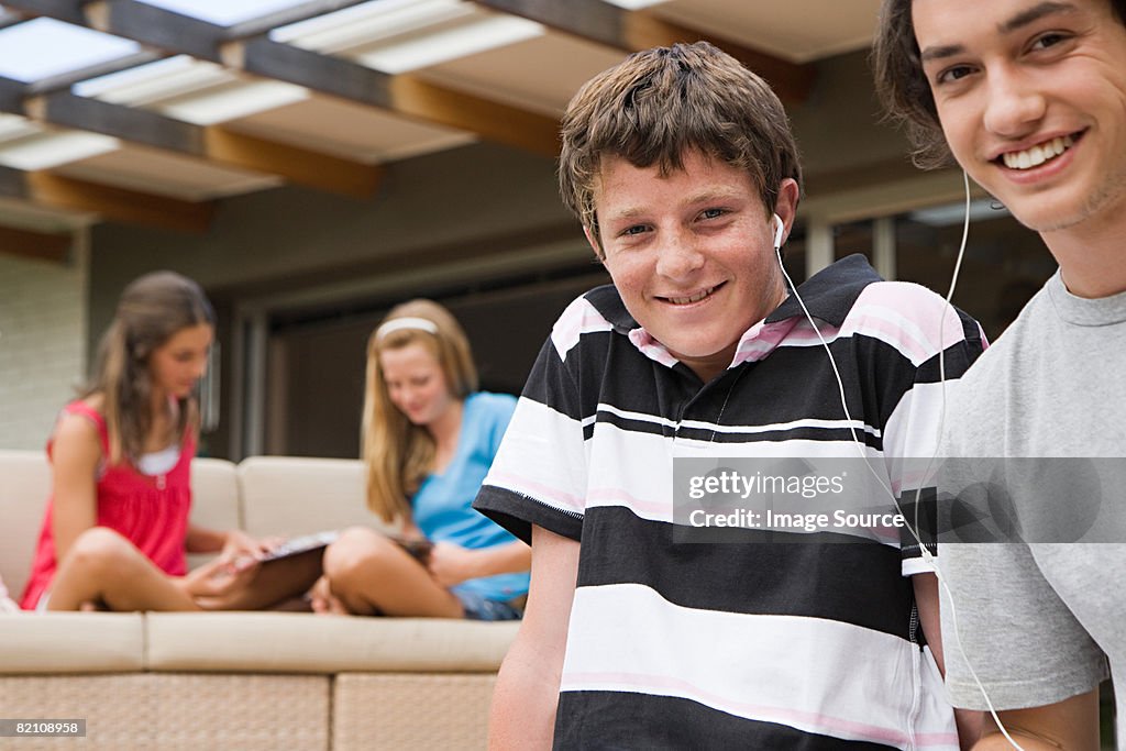 Teenage boys listening to music