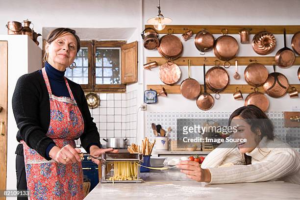 italian women making pasta - italian mother kitchen stock pictures, royalty-free photos & images