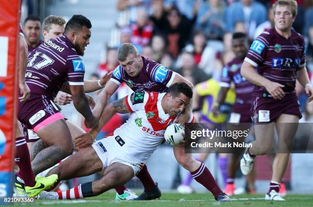 Paul Vaughan of the Dragons crashes over for a try during the round 20 NRL match between the St George Illawarra Dragons and the Manly Sea Eagles at...