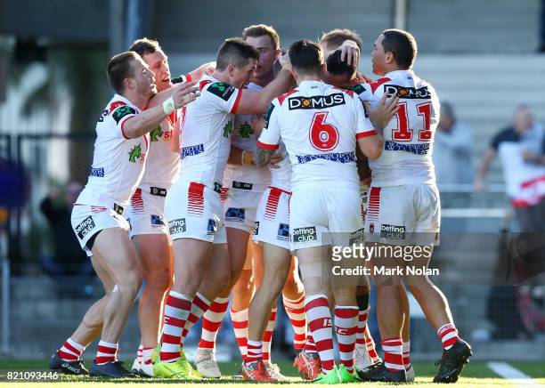 Paul Vaughan of the Dragons celebrates his try with team amtes during the round 20 NRL match between the St George Illawarra Dragons and the Manly...