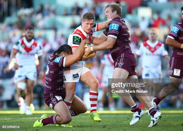 Josh McCrone of the Dragons is tackled during the round 20 NRL match between the St George Illawarra Dragons and the Manly Sea Eagles at WIN Stadium...