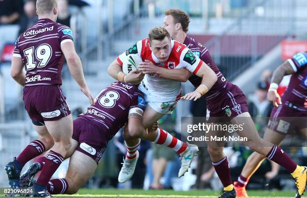 Jacob Host of the Dragons is tackled during the round 20 NRL match between the St George Illawarra Dragons and the Manly Sea Eagles at WIN Stadium on...