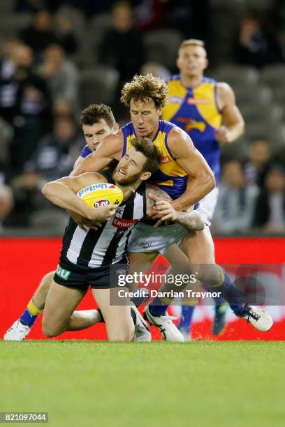 Matt Priddis of the Eagles tackles Jeremy Howe of the Magpies during the round 18 AFL match between the Collingwood Magpies and the West Coast Eagles...