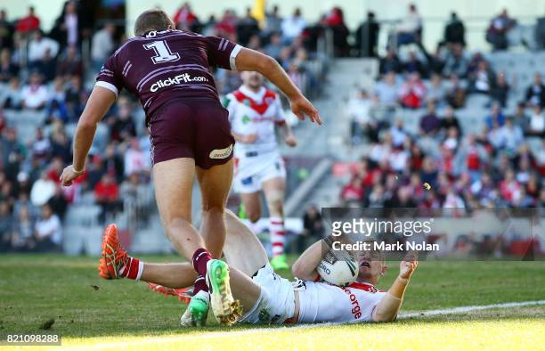 Matthew Dufty of the Dragons is tackled as he scores a try during the round 20 NRL match between the St George Illawarra Dragons and the Manly Sea...