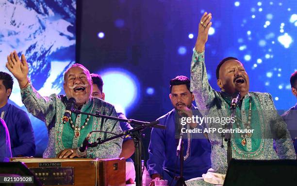 In this photograph taken July 22, 2017 Indian Sufi singers Wadali Brothers Puranchand Wadali and Pyarelal Wadali perform during a promotional event...