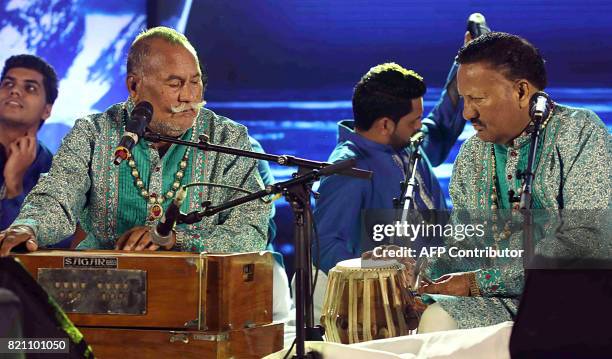 In this photograph taken July 22, 2017 Indian Sufi singers Wadali Brothers Puranchand Wadali and Pyarelal Wadali perform during a promotional event...