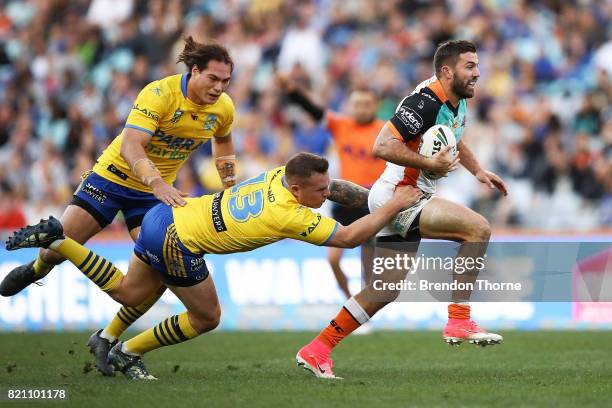 James Tedesco of the Tigers runs the ball during the round 20 NRL match between the Wests Tigers and the Parramatta Eels at ANZ Stadium on July 23,...