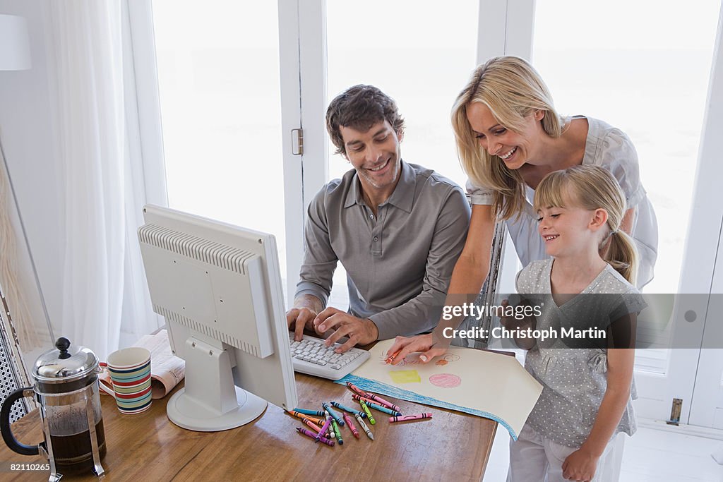 A family looking at a laptop