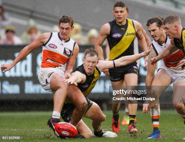 Jack Riewoldt of the Tigers tries to spoil a kick by Harry Perryman of GWS during the round 18 AFL match between the Richmond Tigers and the Greater...