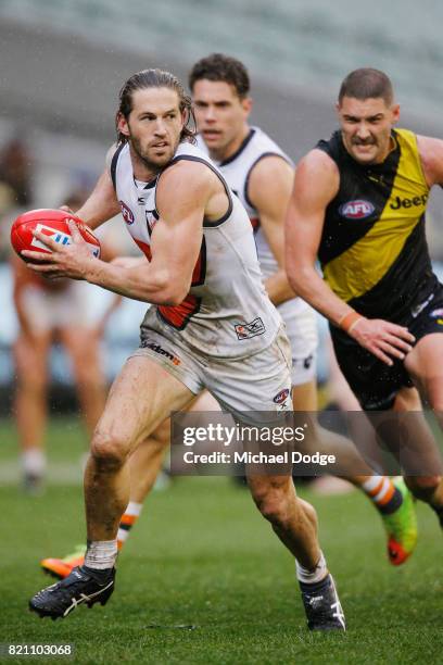 Callan Ward of the Giants runs with the ball during the round 18 AFL match between the Richmond Tigers and the Greater Western Sydney Giants at...