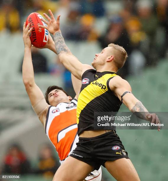 Brandon Ellis of the Tigers and Matthew Kennedy of the Giants compete for the ball during the 2017 AFL round 18 match between the Richmond Tigers and...