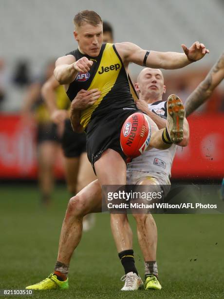 Josh Caddy of the Tigers is tackled by Tom Scully of the Giants during the 2017 AFL round 18 match between the Richmond Tigers and the GWS Giants at...