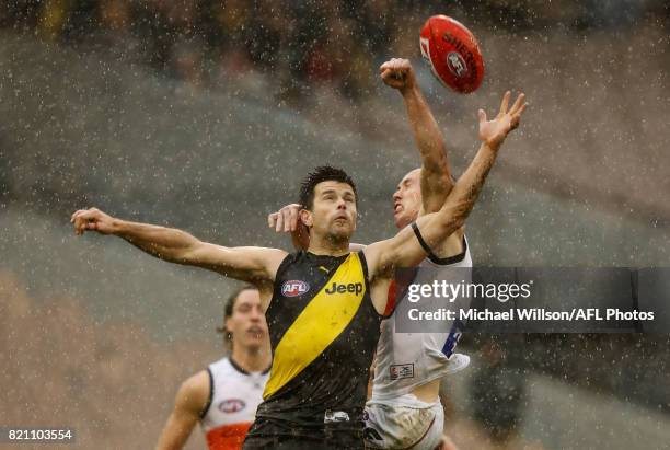 Trent Cotchin of the Tigers and Tom Scully of the Giants compete for the ball during the 2017 AFL round 18 match between the Richmond Tigers and the...