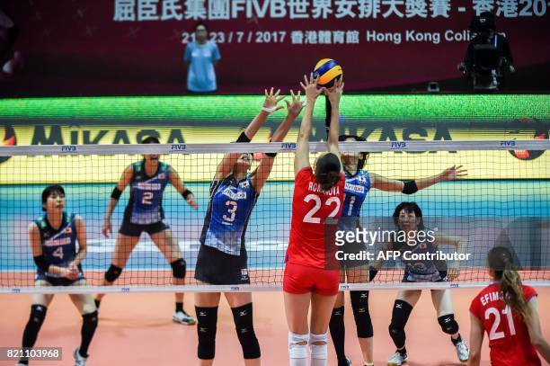Tatiana Romanova of Russia and Yurie Nabeya of Japan compete for the ball during a match at the Women's Volleyball World Grand Prix in Hong Kong on...