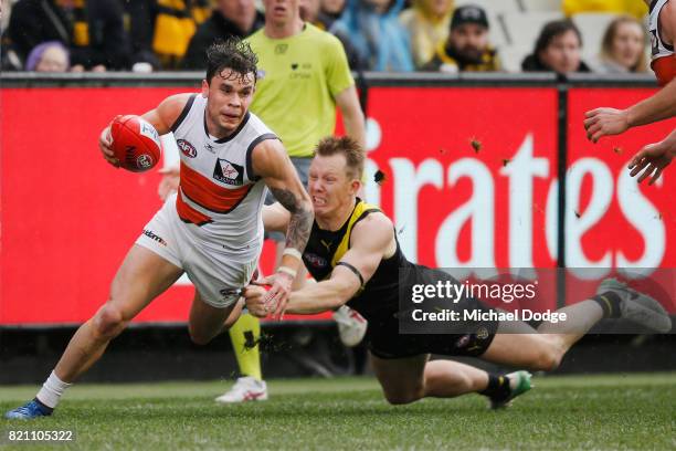 Jack Riewoldt of the Tigers tackles Zac Williams of the Giants during the round 18 AFL match between the Richmond Tigers and the Greater Western...