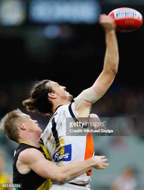 Phil Davis of the Giants punches the ball from Jack Riewoldt of the Tigers during the round 18 AFL match between the Richmond Tigers and the Greater...