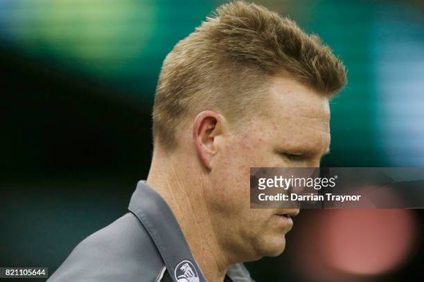 Nathan Buckley, Senior Coach of the Magpies walks down to the three quarter time huddle during the round 18 AFL match between the Collingwood Magpies...