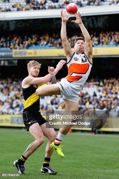 Toby Greene of the Giants marks the ball against Nathan Broad of the Tigers during the round 18 AFL match between the Richmond Tigers and the Greater...