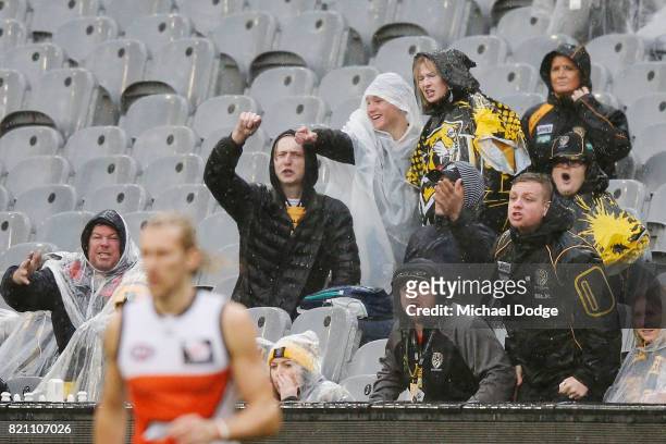 Tigers fans react after a decision during the round 18 AFL match between the Richmond Tigers and the Greater Western Sydney Giants at Melbourne...
