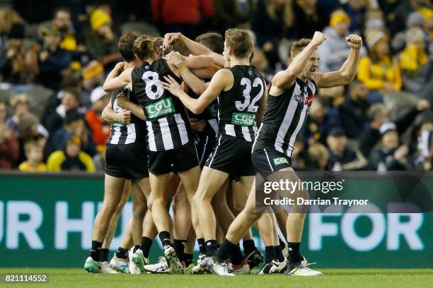 Collingwood players celebrates the final goal during the round 18 AFL match between the Collingwood Magpies and the West Coast Eagles at Etihad...