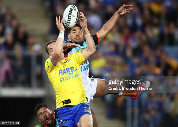 Brad Takairangi of the Eels competes with Esan Nike Marsters of the Tigers during the round 20 NRL match between the Wests Tigers and the Parramatta...