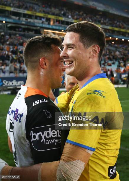 Mitchell Moses of the Eels hugs Luke Brooks of the Tigers following the round 20 NRL match between the Wests Tigers and the Parramatta Eels at ANZ...