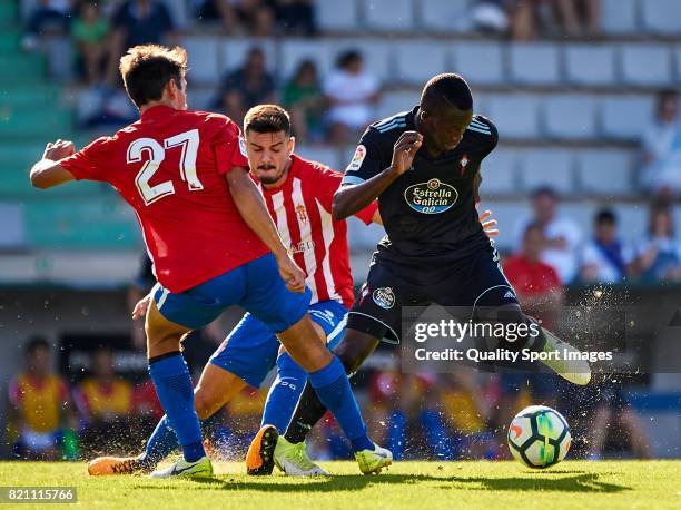 Pape Cheikh of Celta de Vigo competes for the ball with Pedro Diaz and Sergio Alvarez of Sporting de Gijon during the pre-season friendly match...