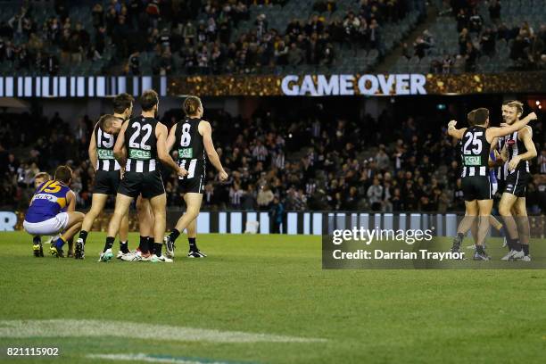 Collingwood players celebrates after the round 18 AFL match between the Collingwood Magpies and the West Coast Eagles at Etihad Stadium on July 23,...