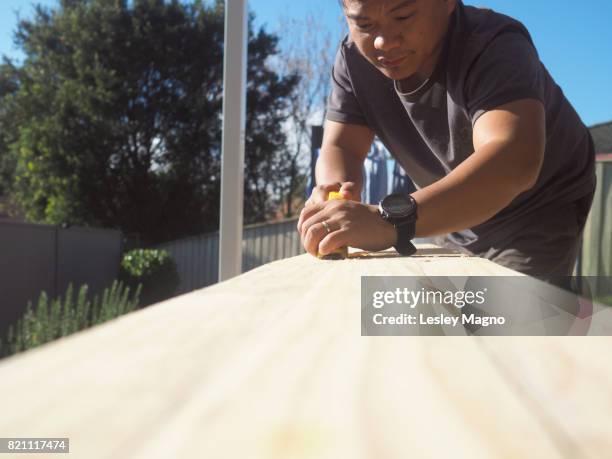 35-40 year old man is doing carpentry using pallet wood - 39 year old stock-fotos und bilder