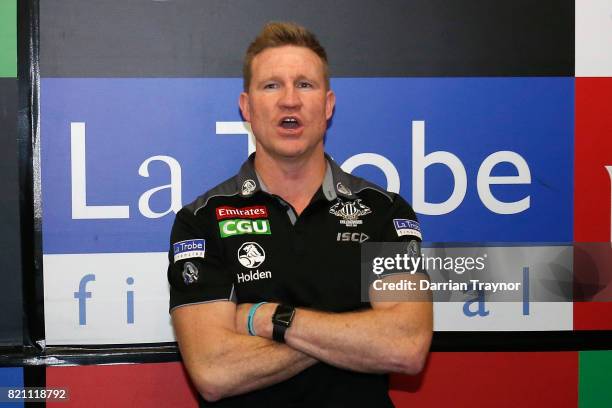 Nathan Buckley, Senior Coach of the Magpies sings the team song in the rooms after the round 18 AFL match between the Collingwood Magpies and the...