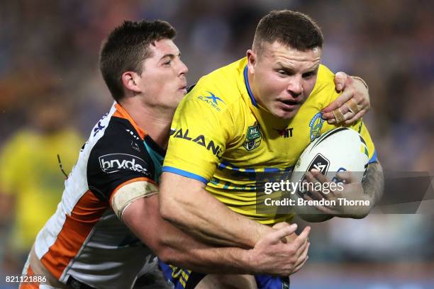 Nathan Brown of the Eels is tackled by the Tigers defence during the round 20 NRL match between the Wests Tigers and the Parramatta Eels at ANZ...