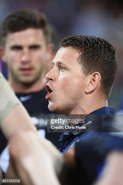 Blues coach Brendon Bolton talks to players during the round 18 AFL match between the Brisbane Lions and the Carlton Blues at The Gabba on July 23,...