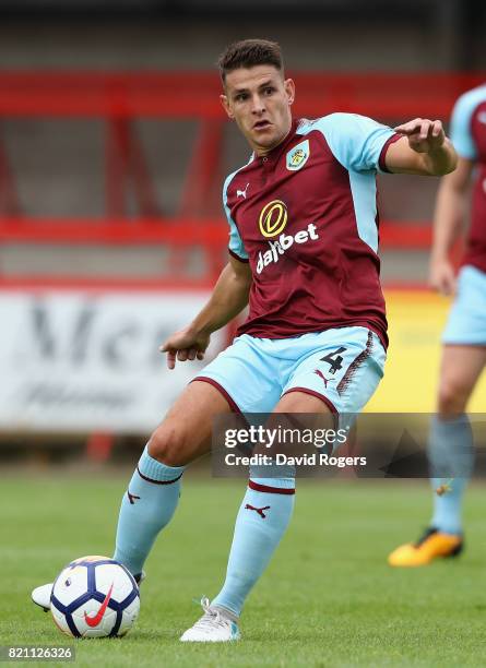 Ashley Westwood of Burnley passes the ball during the pre season friendly match between Kidderminster Harriers and Burnley at Aggborough Stadium on...