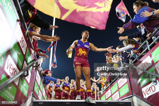 Cedric Cox of the Lions leaves the field after winning the round 18 AFL match between the Brisbane Lions and the Carlton Blues at The Gabba on July...