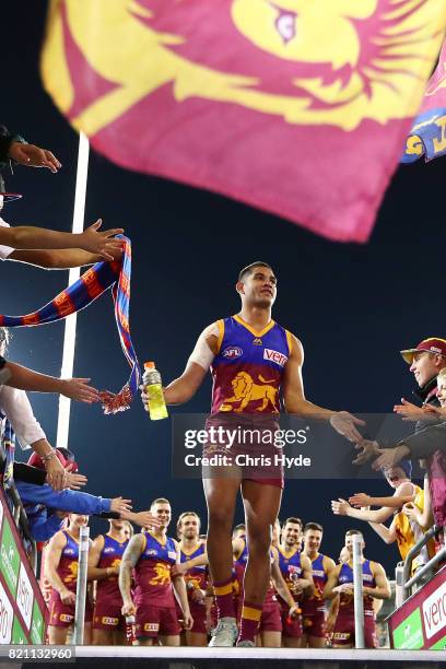 Cedric Cox of the Lions leaves the field after winning the round 18 AFL match between the Brisbane Lions and the Carlton Blues at The Gabba on July...