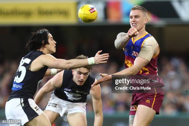 Dayne Beams of the Lions handballs during the round 18 AFL match between the Brisbane Lions and the Carlton Blues at The Gabba on July 23, 2017 in...