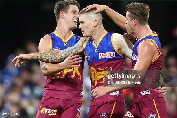 Dayne Beams of the Lions celebrates a goal with team mates during the round 18 AFL match between the Brisbane Lions and the Carlton Blues at The...