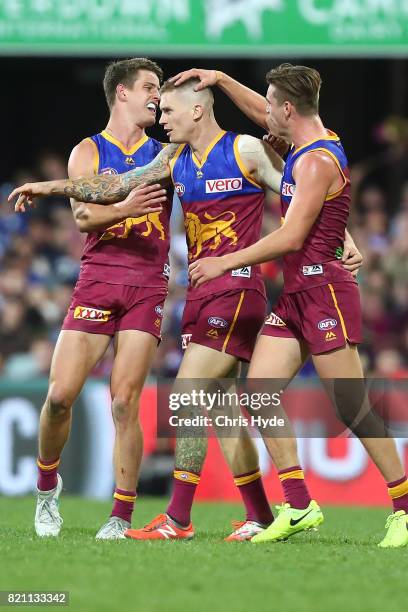 Dayne Beams of the Lions celebrates a goal with team mates during the round 18 AFL match between the Brisbane Lions and the Carlton Blues at The...