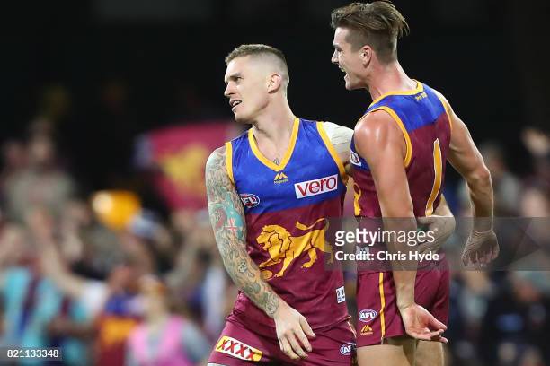 Dayne Beams of the Lions celebrates a goal with team mates during the round 18 AFL match between the Brisbane Lions and the Carlton Blues at The...