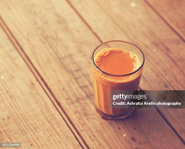 single glass of chai tea on table top - chai tea stock pictures, royalty-free photos & images