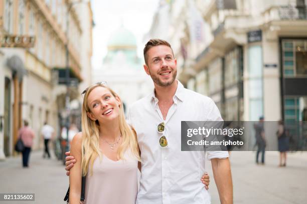 beautiful young tourist couple on city break - pedestrian zone stock pictures, royalty-free photos & images