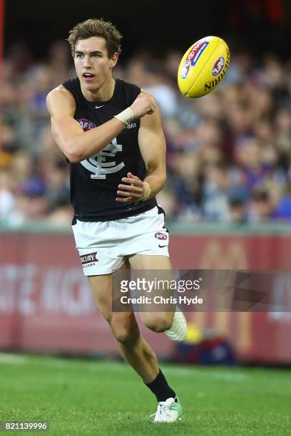 Tom Williamson of the Blues handballs during the round 18 AFL match between the Brisbane Lions and the Carlton Blues at The Gabba on July 23, 2017 in...