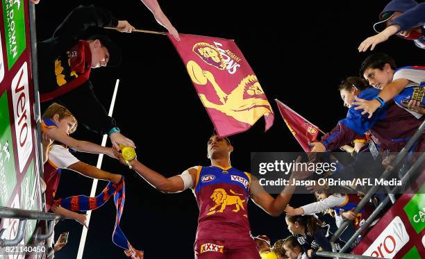 Cedric Cox of the lions celebrates with fans during the round 18 AFL match between the Brisbane Lions and the Carlton Blues at The Gabba on July 23,...